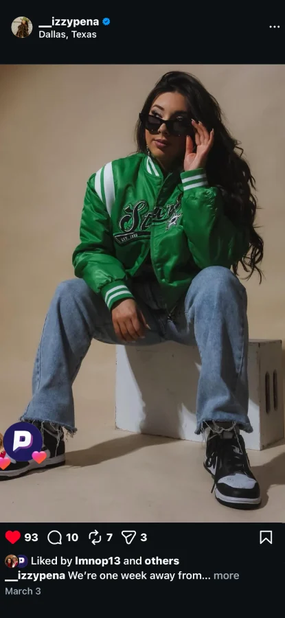A fan in a Stars jacket posing for a post